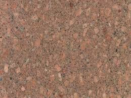 Copper Silk Granite slab &mdash; warm copper-orange to terracotta with silky flowing mineral patterns